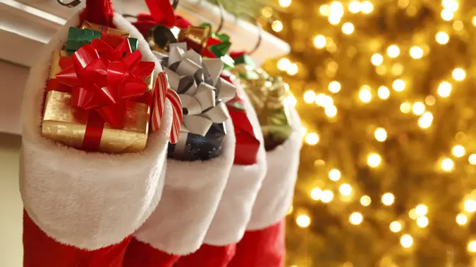 Christmas stockings in front of a blurred Christmas tree.