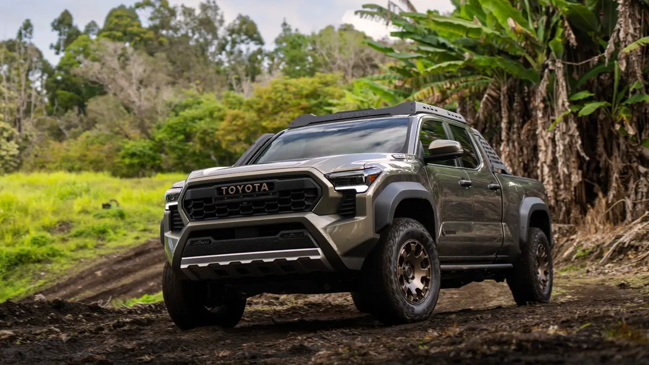 2024 Toyota Tacoma parked in a forested environment for promotional photo.
