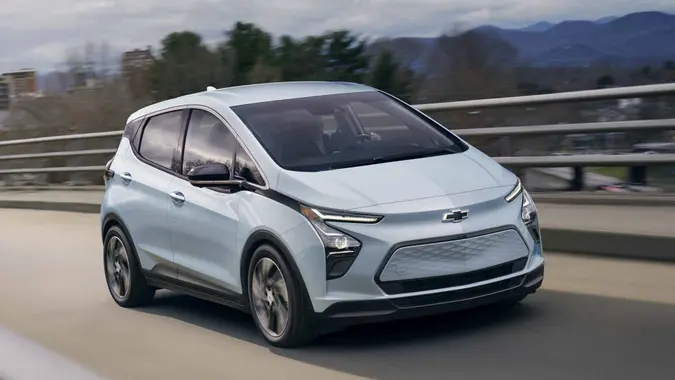 2023 Bolt EV front three-quarter driving on an overpass.