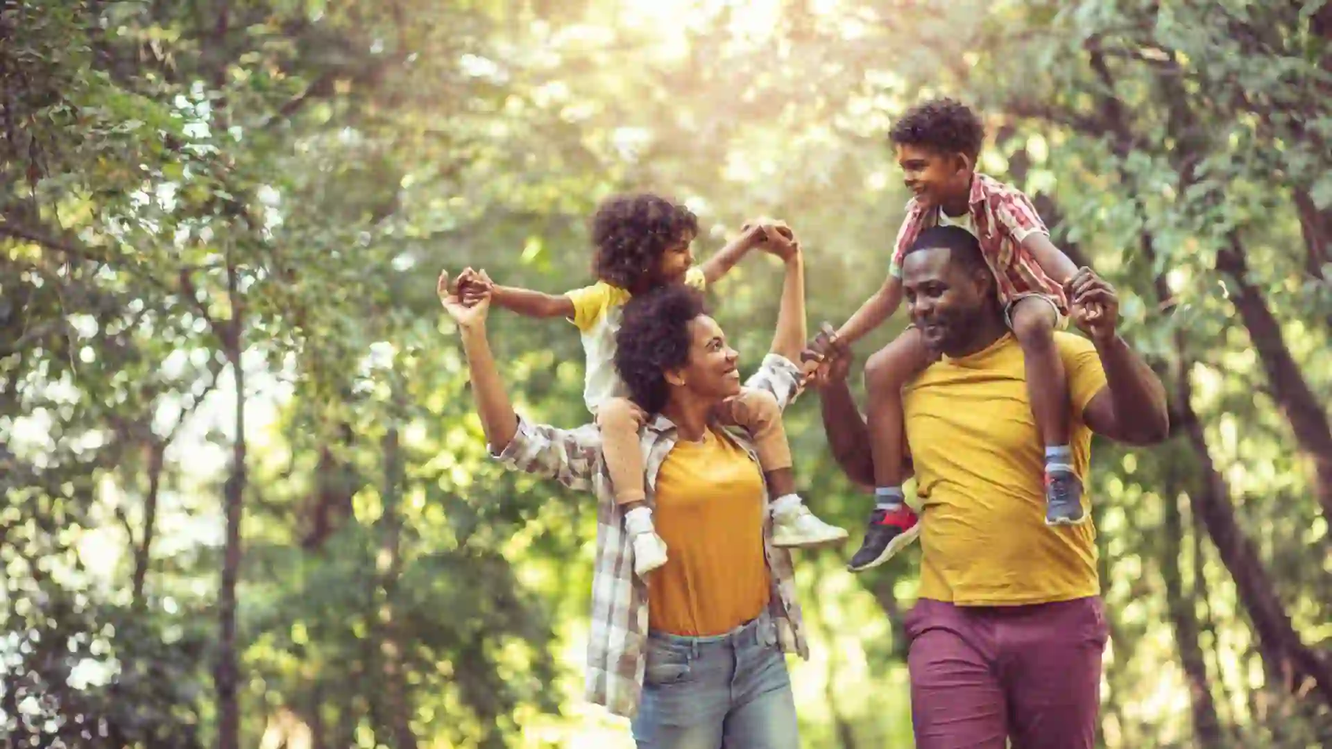 African American family walking trough park.