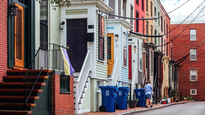 Portland, Maine, USA - Postal worker walks infront of colorful homes.