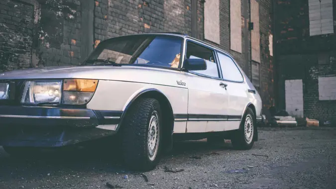 Maardu, Estonia - May 1, 2013: Early 80s classic Saab 900 Turbo parked near the wall of old abandoned factory.