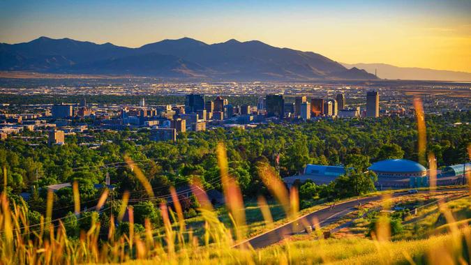 Salt Lake City skyline at sunset with Wasatch Mountains in the background, Utah, USA.