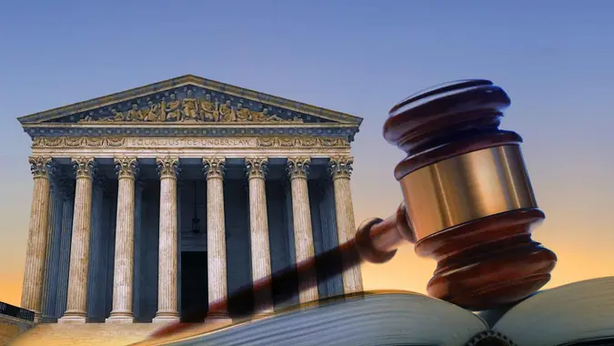 A gavel rests on top of an open law book with the U.
