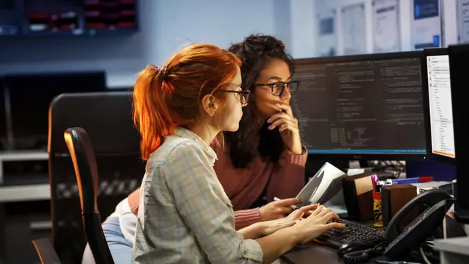Two female programmers working on new project.