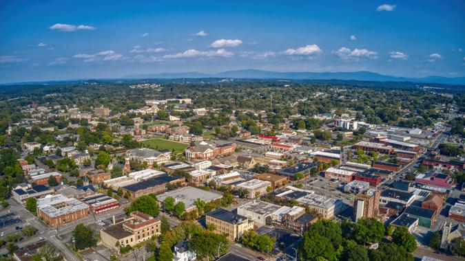 An aerial view of Downtown Cleveland, Tennessee with dense buildings under a blue sky with tiny clouds.