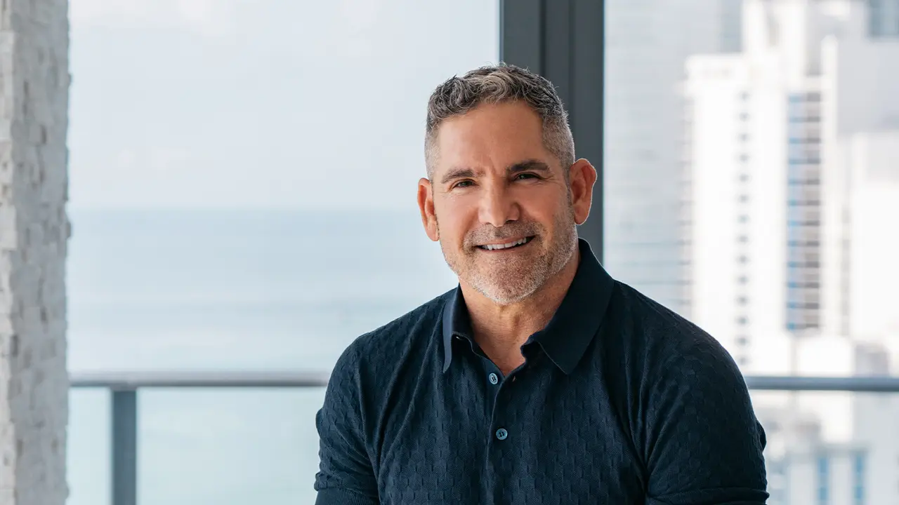Grant Cardone smiling while sitting in a Penthouse