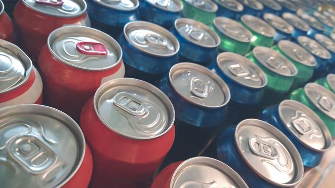 Rows of colorful metal cans with soda drink in shop stock photo