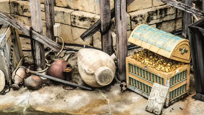 gold in old treasure chest in ruins.