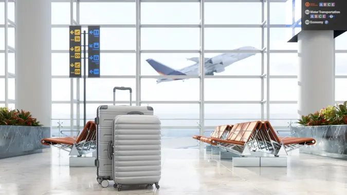 Airport waiting area with luggage, empty seats and blurred background Stock photo