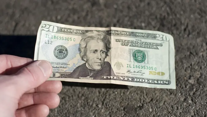 Find a 20$ bill on the street stock photo
