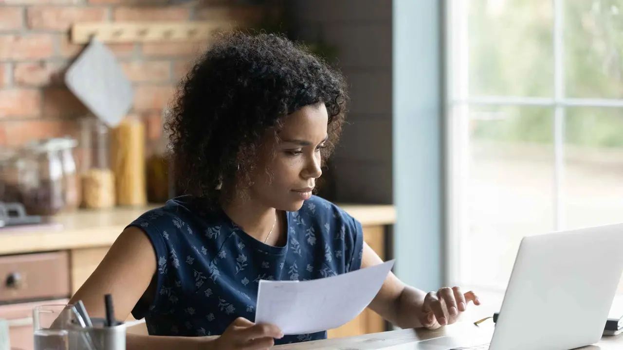 A woman prepares her financial or tax forms.