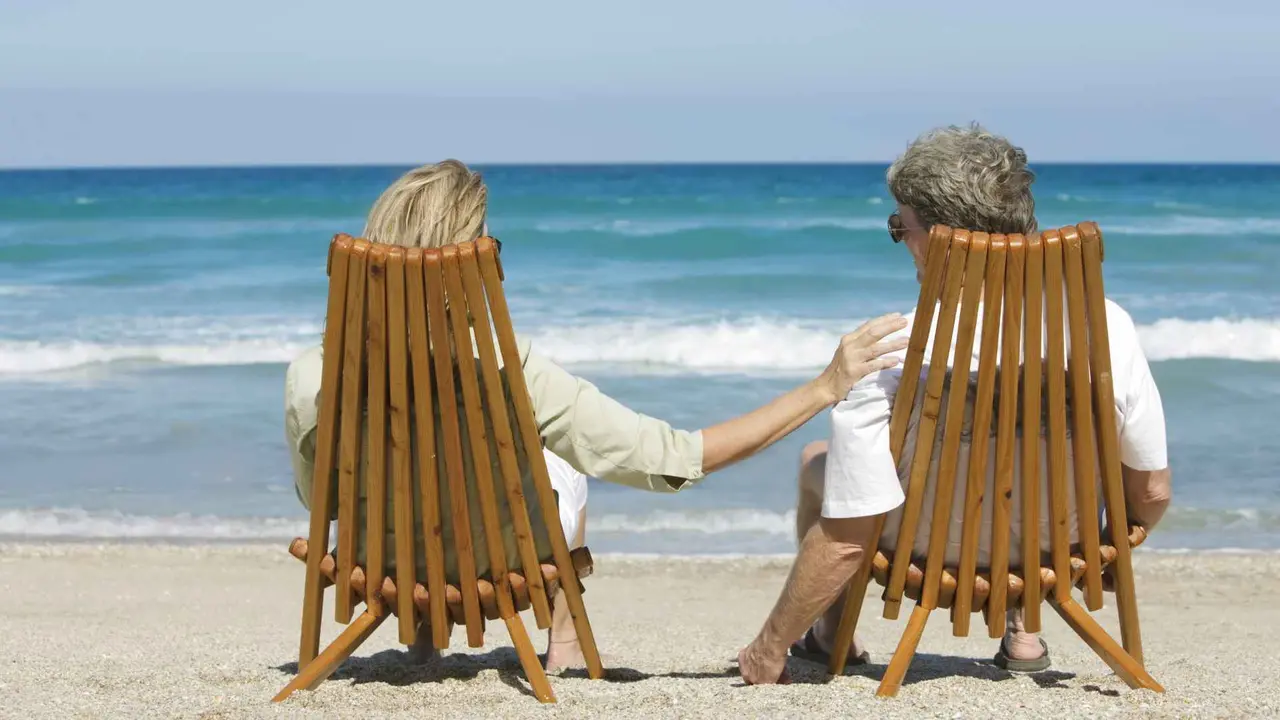 couple relaxing in chairs at the beach.