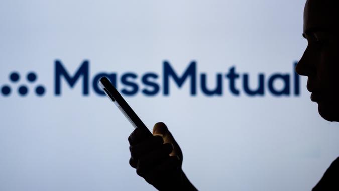 Logo illustration displayed on smartphones in Brazil - 28 Jun 2022 : Mandatory Credit Photo Rafael Henrique/SOPA Images/Shutterstock (BLU_A60813559) : In this photo illustration, the Massachusetts Mutual Life Insurance Company (MassMutual) logo is seen in the background of a silhouetted woman holding a mobile phone.