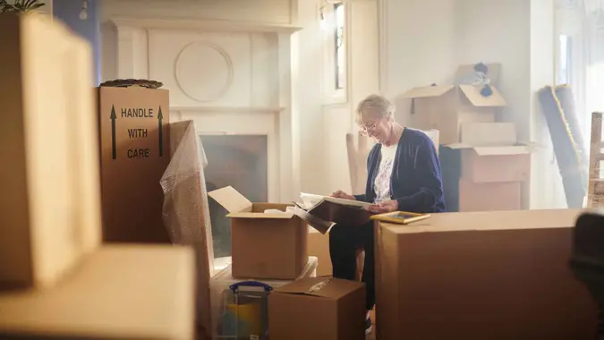 senior woman looks through some memories just before the house move begins.