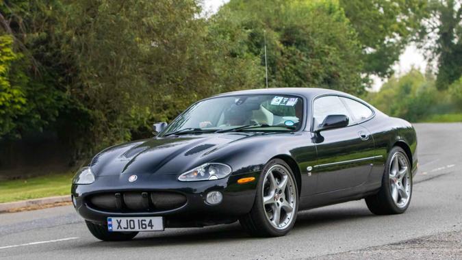 Whittlebury,Northants,UK -Aug 26th 2023: 2003 black Jaguar XKR car travelling on an English country road.