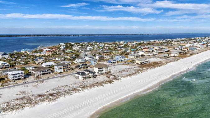 Beautiful homes along the Gulf Coast beach at Pensacola Beach, Florida shot from an altitude of about 600 feet over the Gulf of Mexico.