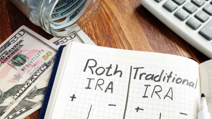 Roth IRA vs Traditional IRA written in the notepad.