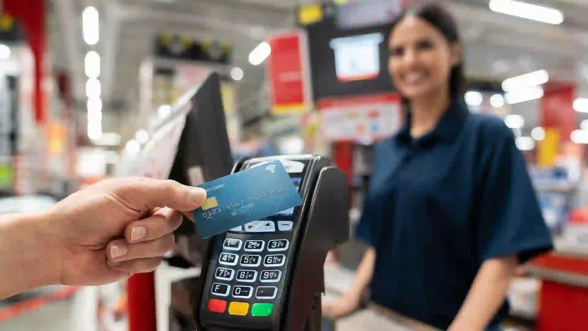 Close-up on a customer making a smart payment at the hardware store - business concepts.