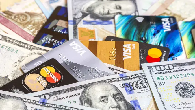 Moscow, Russia - January 4, 2021: MasterCard and Visa with american dollars and others banknotes.