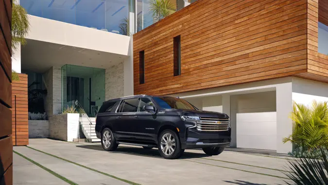 The 2023 Suburban High Country front three-quarter view parked.