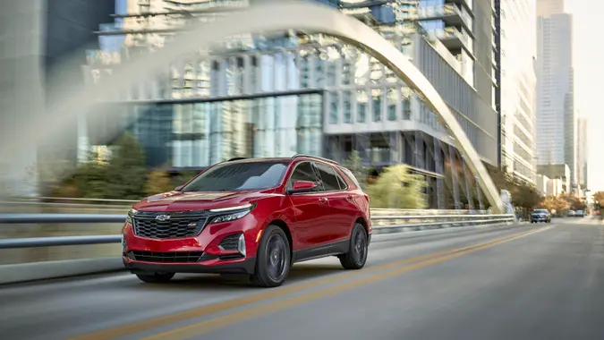 Front 3/4 view of 2024 Chevrolet Equinox RS in Radiant Red Tintcoat.