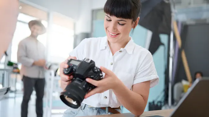 Photography, digital camera and happy woman check photo results, memory picture or Tokyo production. Lens, art creativity process or creative photographer, girl or person doing analysis of photoshoot