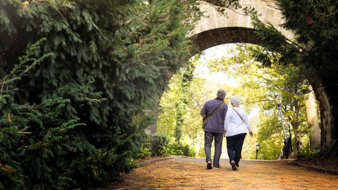 Senior couple discovering New-York City Fort Tryon park in Autumn.