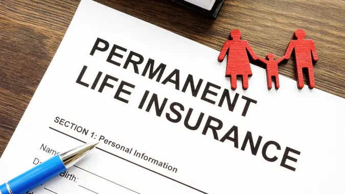 Permanent life insurance application and family figurine. stock photo