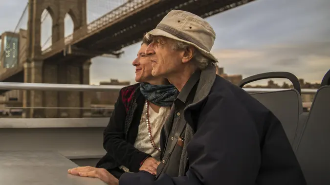The senior couple traveling in Manhattan, New York. Riding the ferry at East River stock photo