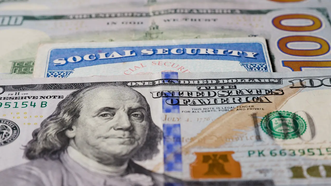Photo of social security card with one hundred dollar bills.