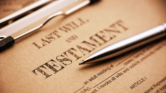 Vintage / retro style : Blue ballpoint pen and a last will and testament on a clip board.