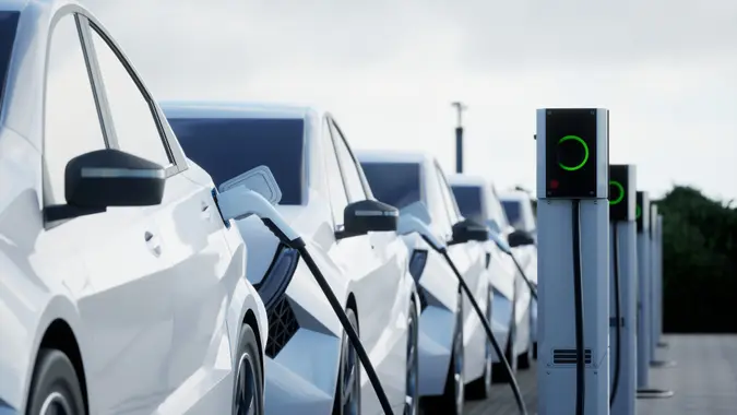 Generic electric car charging on a city street This image doesn`t contain any visible trademarked products, corporate identity, logos, or copyrighted elements