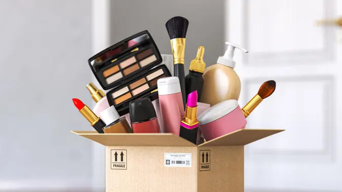 Cardboard box with cosmetics product in front od open door.
