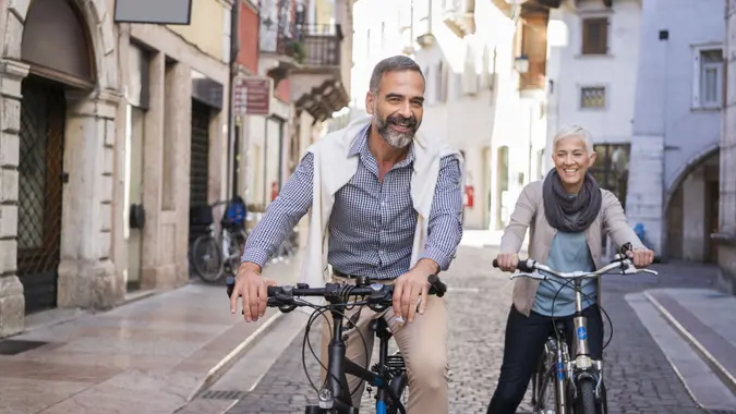 Mature couple exploring city with bicycle's.