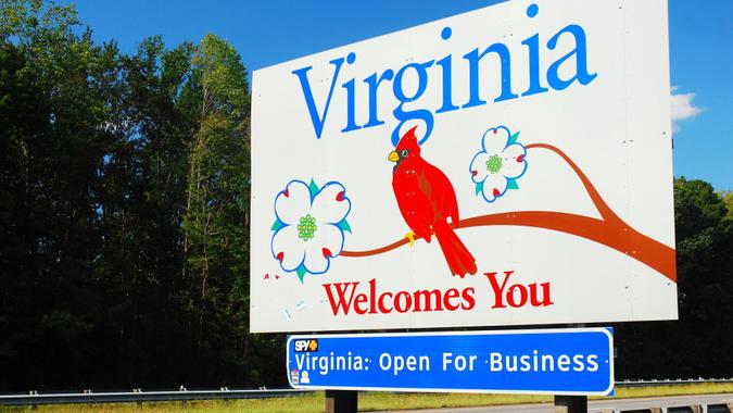 Arlington, VA, USA September 29, 2011 A Sign with a red cardinal, the Virginia state bird, welcomes people to the State of Virginia near Arlington.