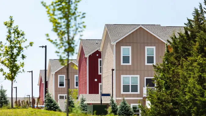 Row of Bright Multi-Colored Homes on a Sunny Summer Day stock photo
