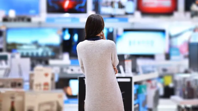 Woman buys the TV stock photo