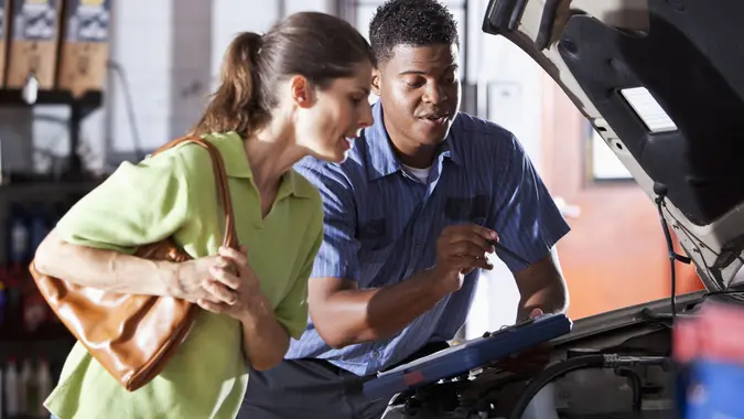 Auto mechanic with customer stock photo