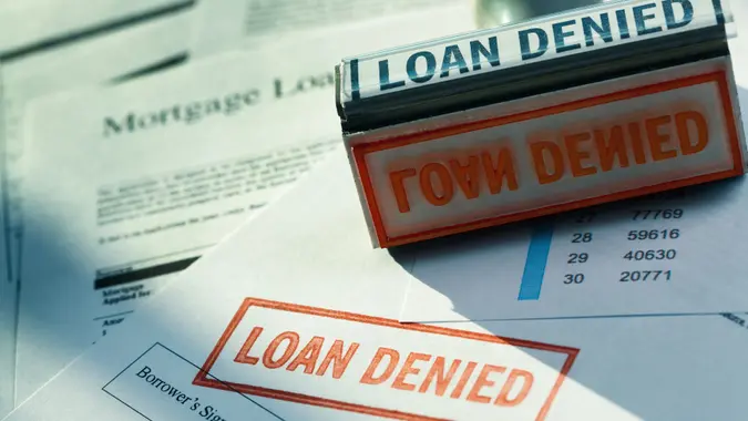 “LOAN DENIED” Red Rubber Stamp Denying Mortgage Lending Application Documents stock photo