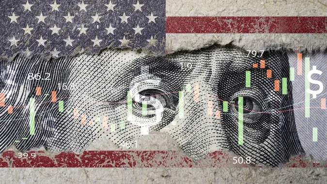 Closeup Benjamin Franklin face on USD banknote with stock market chart graph and United States flag for currency exchange and global trade forex concept. stock photo