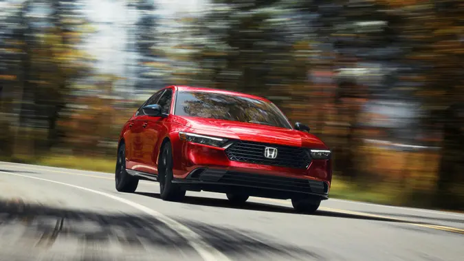 day, daytime, day time, outdoors, exterior, nature, in motion, driving, action, autumn, fall, forest, trees, road, curved road, blur, blurred background