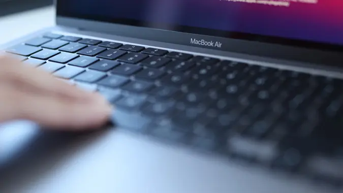 Woman uses an Apple MacBook Air to do work, college studies and other related activities in stock photo