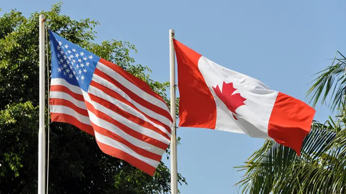 US and canadian flag side by side stock photo