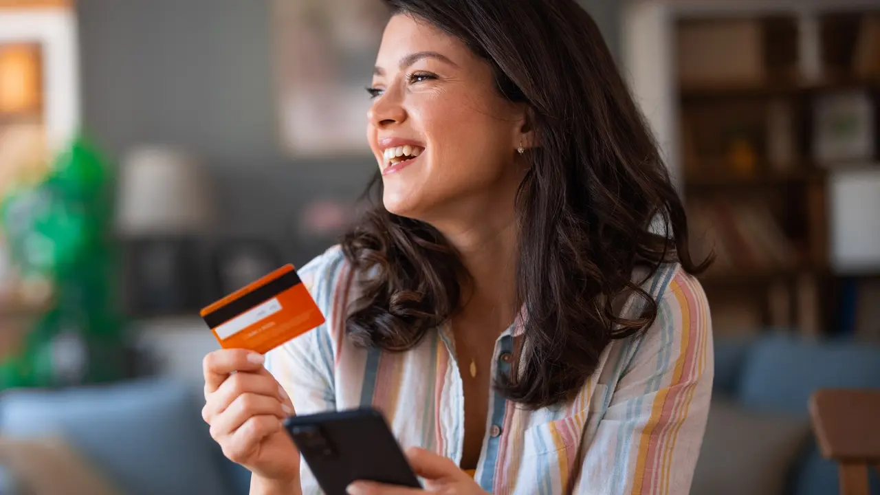 Happy woman shopping online at home stock photo