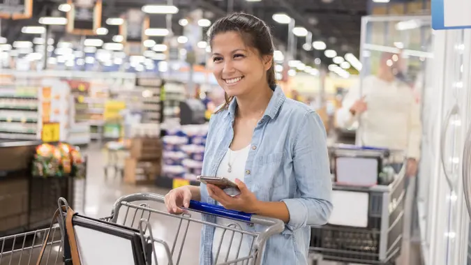 Woman enjoys shopping in bulk foods warehouse stock photo