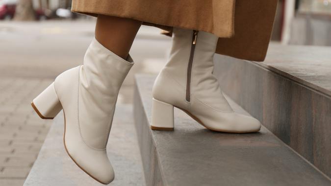 Woman wearing stylish leather shoes on stairs outdoors, closeup stock photo