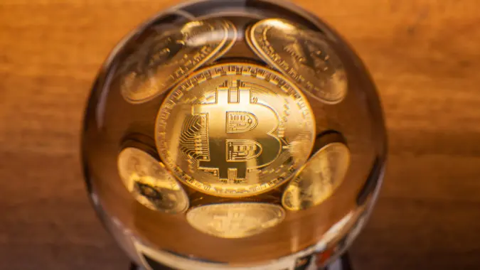 Bitcoin coins in a crystal ball stock photo