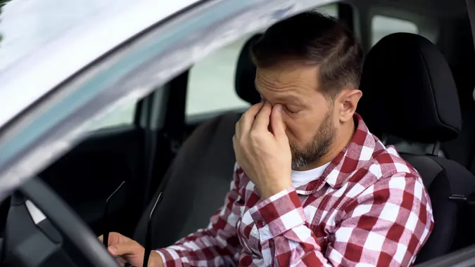 Overworked car driver taking eyeglasses off, eyesight disease, health weakness.