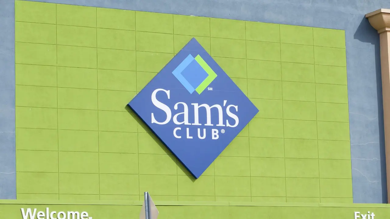 The Sam's Club logo surrounded by a green wall on the exterior of a store.
